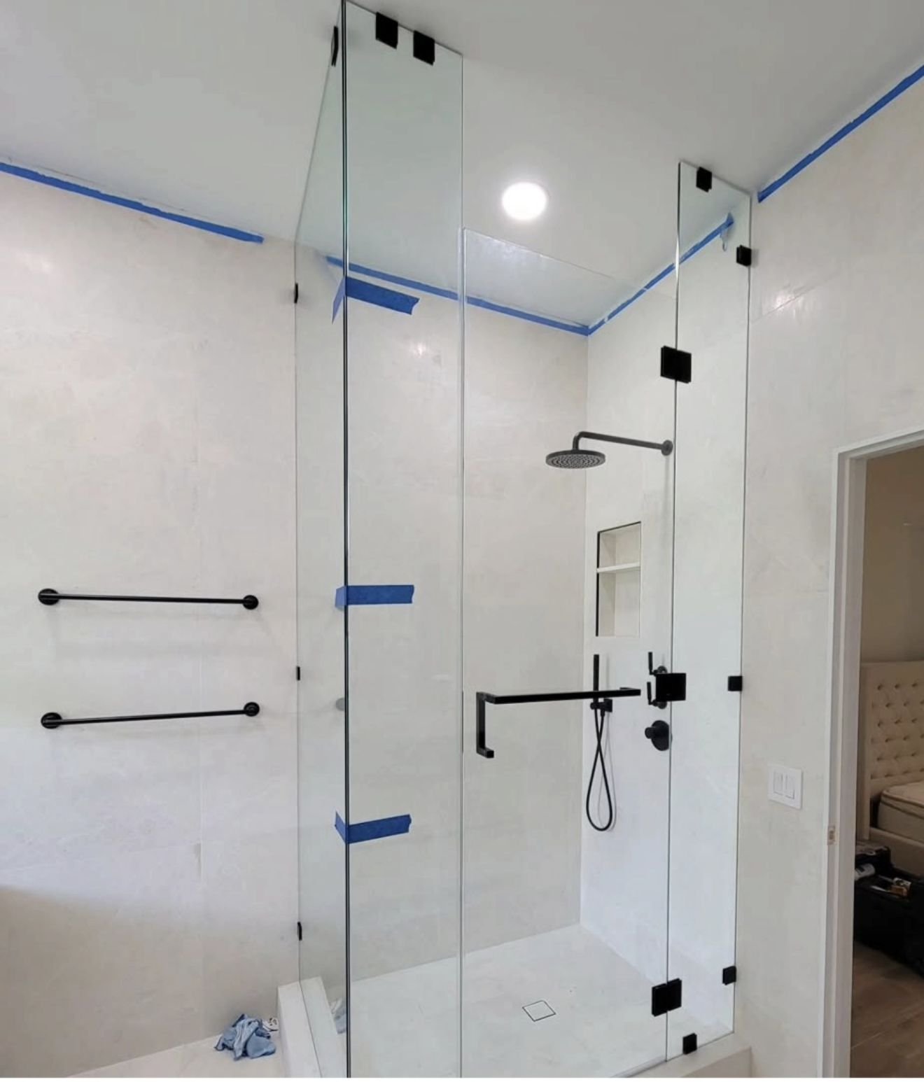 Floor-to-ceiling shower with black hardware